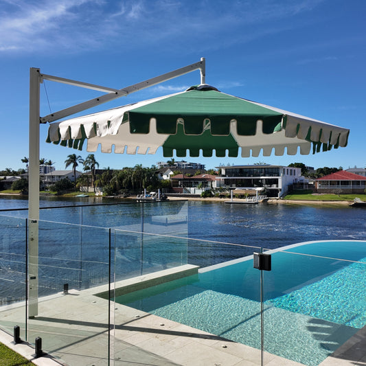 Pool area with a large umbrella and waterfront view